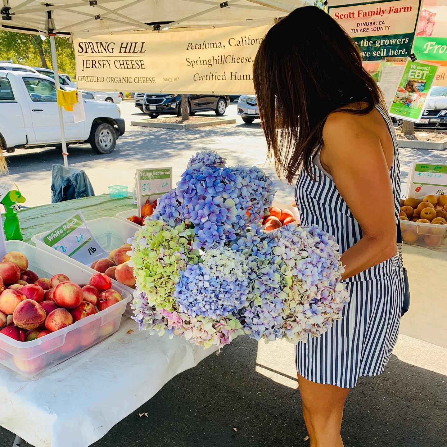 Peaches and floral bouquets at Rancho Cordova Certified Farmers' Market